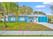 Charming blue single-story home featuring a well-maintained lawn and inviting curb appeal at 1416 E 20Th St, Sanford, FL 32771