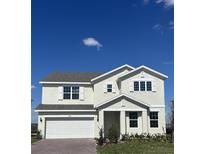 Charming two-story home showcasing a well-manicured lawn and a classic architectural design at 14734 Erice Ave, Clermont, FL 34714