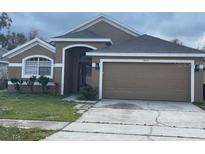 Charming single-story home featuring an attached two-car garage and neutral-toned exterior at 14954 Lady Victoria Blvd, Orlando, FL 32826