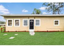 Charming single-story home with a well-maintained lawn and welcoming front entrance at 1622 Dolphin Dr, St Cloud, FL 34771