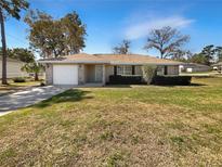 Charming single-story home with a well-maintained lawn, attached garage, and inviting curb appeal at 30 Hemlock Trce, Ocala, FL 34472