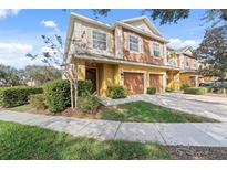 Charming two-story townhome with a two-car garage and well-maintained landscaping at 701 Fortanini Cir, Ocoee, FL 34761