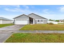 Charming single-story home with well-maintained lawn, driveway and garage at 12853 Maryland Woods Ct, Orlando, FL 32824