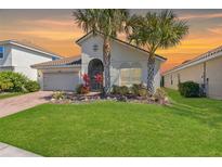 Charming single-story home with well-manicured lawn and mature palm trees in a warm, inviting setting at 1330 Bucktail Ct, Kissimmee, FL 34746