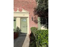 Charming townhouse entrance with a sage colored door and meticulously maintained brick facade at 620 Georgetown Dr # 620, Casselberry, FL 32707