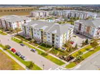 A colorful apartment complex offers a tranquil atmosphere, swimming pool, and lake views at 7517 Laureate Blvd # 4206, Orlando, FL 32827
