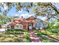 Charming home with brick accents, manicured lawn, and inviting front porch seating at 234 N Lakeview Ave, Winter Garden, FL 34787