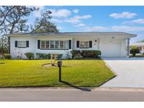 Charming single-story home with a manicured lawn, dark shutters, and an attached one-car garage at 29 Jasmine Dr, Debary, FL 32713