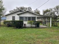 Charming home featuring a covered parking area, front bushes, and a quaint, inviting facade at 3420 Avenue R Nw, Winter Haven, FL 33881