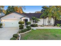 Charming one-story home featuring well-manicured landscaping and an attached two-car garage at 1149 Doyle Rd, Deltona, FL 32725