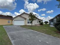Charming single-story home with a well-manicured lawn and inviting curb appeal at 235 Tuscany Pointe Ave, Orlando, FL 32807
