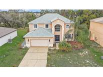 Two-story home featuring a large window, attached garage and a well maintained front yard at 548 Big Sioux Ct, Kissimmee, FL 34759