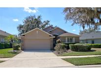 Charming home featuring a manicured lawn, mature landscaping, and a two-car garage at 781 Lakeworth Cir, Lake Mary, FL 32746
