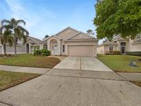 Charming single-Gathering home features a well-maintained lawn and a two-car garage at 1168 Ballyshannon Pkwy, Orlando, FL 32828