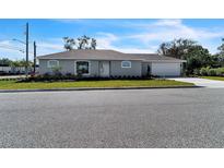 Charming single-story home with a well-manicured lawn and a classic, clean exterior design at 1802 Dixie Belle Dr, Orlando, FL 32812