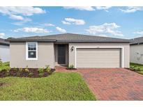 Charming single-story home with a two-car garage and brick-paved driveway at 3190 Viceroy Ct, Poinciana, FL 34759