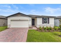 Charming one-story home with a well-manicured lawn and a brick driveway at 3559 Broadwing Blvd, Poinciana, FL 34759