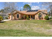 Charming home featuring solar panels and a well-manicured lawn at 2398 Whitehorse St, Deltona, FL 32738