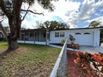 Charming single-story home featuring a screened in porch and an attached one car garage at 2818 Geoffrey Dr, Orlando, FL 32826
