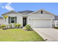 Charming single-story home with well-manicured lawn, two car garage, and neutral paint scheme at 3771 Whitetail Ct, St Cloud, FL 34772