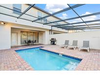 Inviting private pool area with lounge chairs and an outdoor grill, perfect for relaxation and entertaining at 8879 Geneve Ct, Kissimmee, FL 34747