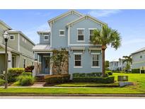 Charming two-story home with light blue siding, stone accents, and a well-manicured lawn at 1511 Fairview Cir, Kissimmee, FL 34747