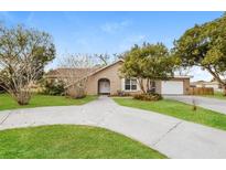 Charming single-story home featuring a welcoming front yard and curved driveway at 1582 Darlington Ave, Deltona, FL 32725