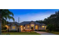 Beautiful single-story home featuring manicured landscaping, a tile roof, and a welcoming stone-accented facade at 1726 Brackenhurst Pl, Lake Mary, FL 32746