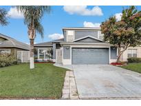 Charming two-story home with a well-manicured lawn and a two-car garage at 2570 Chatham Cir, Kissimmee, FL 34746