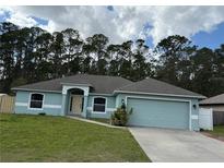 Charming single-story home featuring a well-manicured lawn and attached two-car garage, perfect for suburban living at 3200 Utah Dr, Deltona, FL 32738