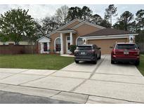 Charming single-story home featuring a manicured lawn and inviting facade, with a spacious driveway at 3220 Town And Country Rd, Oviedo, FL 32766