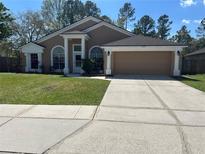 Charming single-story home with a well-maintained lawn and a two car garage at 3220 Town And Country Rd, Oviedo, FL 32766