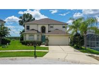 Charming two-story home featuring a well-manicured lawn and a convenient two-car garage at 523 Higher Combe Dr, Davenport, FL 33897