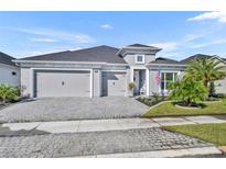 Charming single-story home with three-car garage and a well-manicured front yard at 585 Mosaic Blvd, Daytona Beach, FL 32124