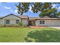 Charming single-story home with a well-manicured lawn and inviting curb appeal at 7037 Edgeworth Dr, Orlando, FL 32819