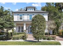 Charming two-story home with manicured landscaping and inviting front porch, enhancing curb appeal at 909 E Central Blvd, Orlando, FL 32801