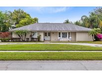 Charming single-story home with a well-manicured lawn, lush landscaping, and inviting curb appeal at 922 Puma Trl, Winter Springs, FL 32708