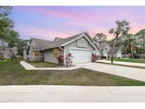 Charming single-story home features a two-car garage, well-manicured lawn, and mature landscaping at 2007 Cornell Pl # 4, Port Orange, FL 32128