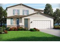 Charming two-story home with blue shutters, stone accents, landscaped yard, and two-car garage at 2102 Rosewood Dr, Bartow, FL 33830