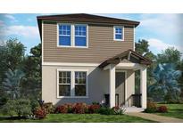 Charming two-story home featuring a covered front porch, complemented by lush landscaping at 5099 Railroad Vine Aly, Winter Garden, FL 34787