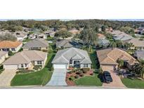 Charming single-story home with well-manicured landscaping and an attached two-car garage at 7233 Se 171St Pond Ln, The Villages, FL 32162