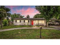 Charming single story home with a well maintained lawn, walkway, and bright red front door under a covered porch at 1412 Lakecrest Dr, Apopka, FL 32703