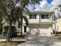 Inviting two-story home with a manicured lawn, two-car garage, and classic architectural details at 1714 Sherbourne St, Winter Garden, FL 34787