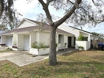 Charming home featuring a well-maintained lawn, attached garage, and inviting curb appeal at 2452 Atrium Cir, Orlando, FL 32808