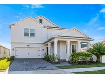 Charming two-story home featuring a brick driveway, an attached two-car garage, and manicured landscaping at 3070 Prelude Ln, Kissimmee, FL 34746