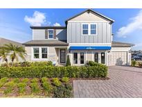 Charming two-story home featuring stone accents, landscaped yard, and a welcoming front entrance at 3235 Legends Preserve Dr, Daytona Beach, FL 32124