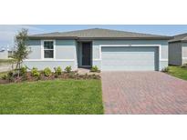 Charming single-story home featuring a brick driveway, a two-car garage, and a well-manicured lawn at 3809 Giorgio Dr, Winter Haven, FL 33884