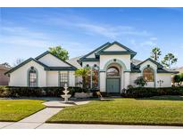 Charming home featuring a well-manicured lawn, inviting fountain, and a beautifully designed front facade at 736 W Pinewood Ct, Lake Mary, FL 32746