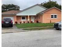 Charming single-story home with an attached garage and well-maintained front yard at 8670 Oak Bluff Dr, Orlando, FL 32827