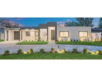 Modern home featuring manicured lawn, striking block driveway, and minimalist design at 2015 Summerfield Rd, Winter Park, FL 32792
